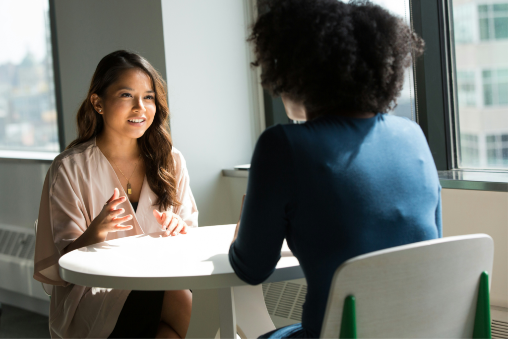 Interview panel and candidate in a calm, well-lit meeting room